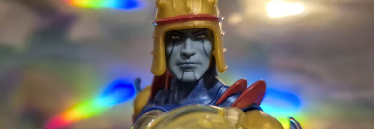 The Masterverse Sy-Klone action figure looking determined while holding his shield in front of him.