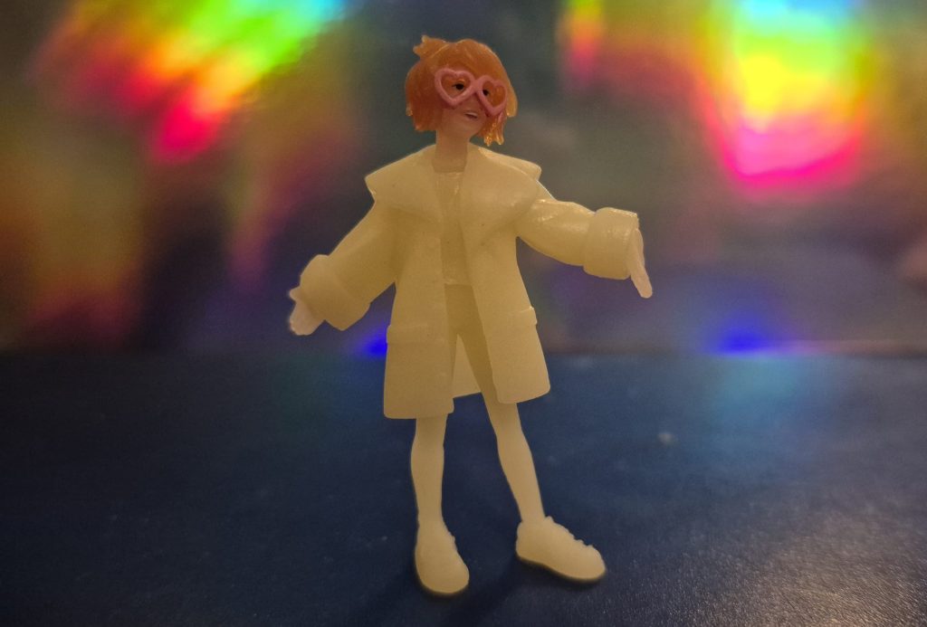 A tiny figurine of LYLA, Miguel O'Hara's AI partner.